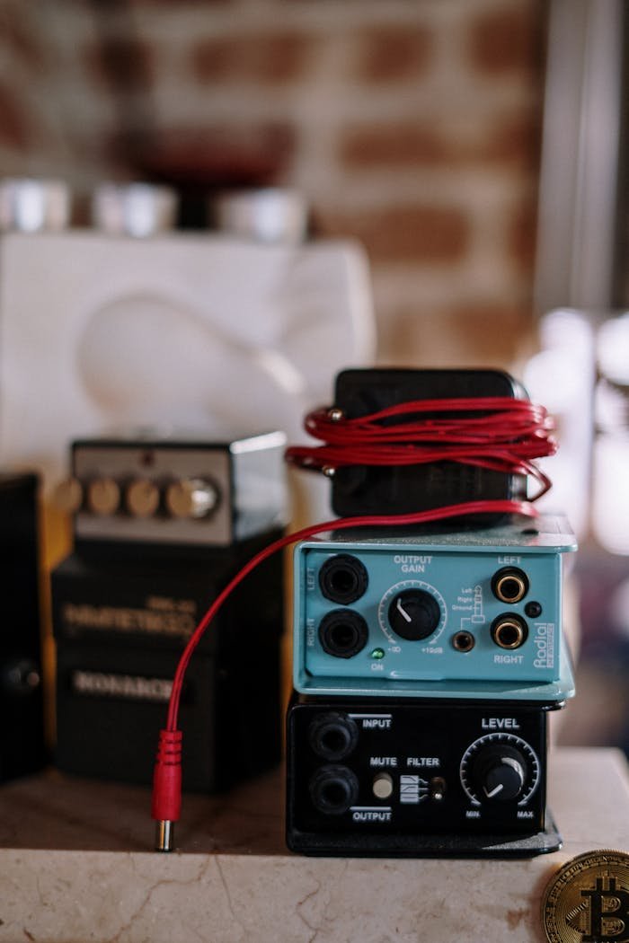 A detailed shot of audio equipment in a home studio setup, showcasing electronic devices and wiring.